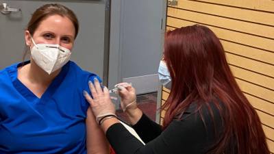 Wantage resident Ashlie Qualagari, an LPN at Wellness Center Pediatrics, receives her COVID-19 vaccine from RoNetco’s Nicole Gong, PharmD.