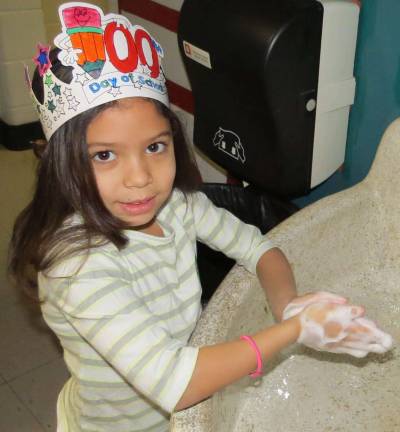 Hats Off to the 100th Day of School Vicely Cepeda, a second grader in Carol Navitsky' class (taking a break to wash her hands).