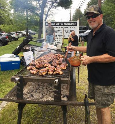 Paupack United Methodist Women will host their annual flea market and chicken barbecue on Aug. 12 Bill Lukacinsky mans the grill at last year’s flea market/chicken barbecue at the Paupack United Methodist Church. Provided photo.