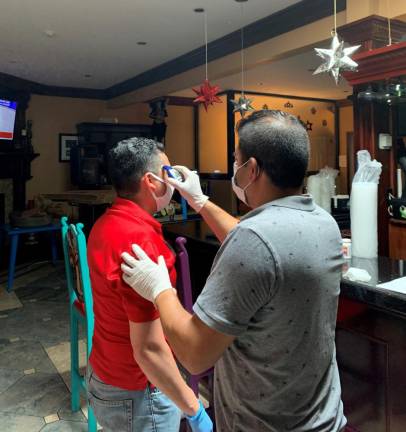 Employees check their temperatures at Hacienda in Goshen, N.Y.