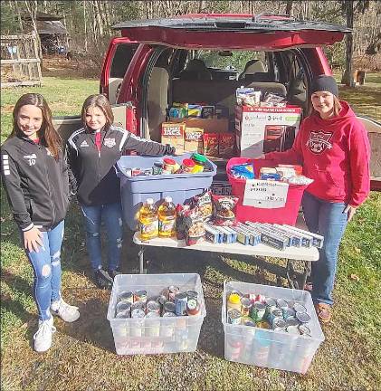 Emma Wells, Lily Wells,and their mom, Megan Wells, collected seven totes on behalf of the Eastern Pike Soccer Club for the Ecumenical Food Pantry for the Christmas season distribution. They set up donation bins and asked players and family to bring non-perishable items to area games. Megan said her daughters had a wonderful time soliciting donations and sorting the goods. She hopes to do this food drive again next year. Provided photos.