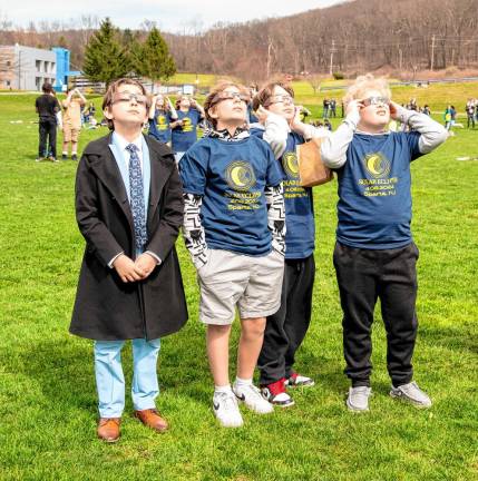 Watching the eclipse are Sparta Middle School students Hayden Wilson, Holden Richardson, Kyler Schwarz and Hunter Richardson. (Photo by Nancy Madacsi)