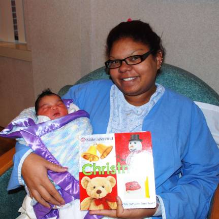Babies get free books donated to promote literacy Valeria Urquijo of Milford accepted a free book for her newborn son, Devin (Photo provided)