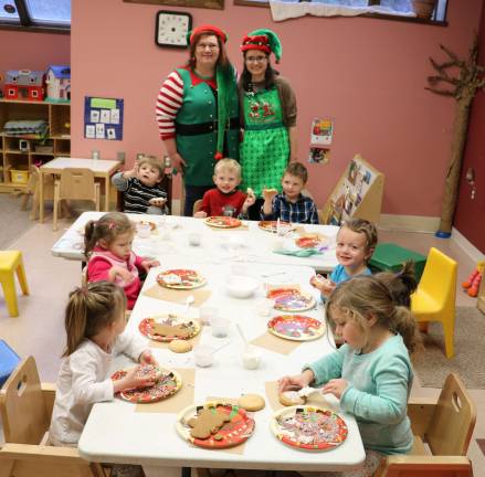 Elf-dieticians help children at CDD decorate gingerbread cookies The children display their handiwork (Photo provided)