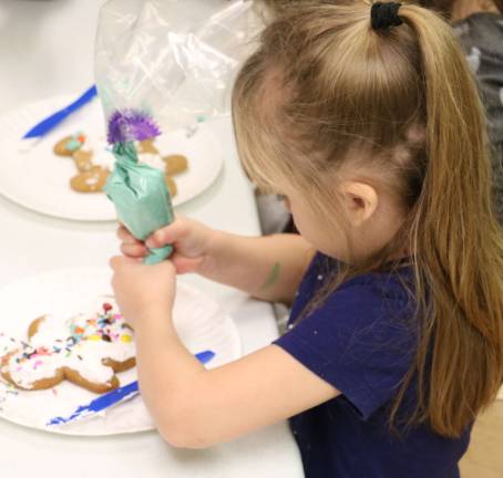 Elf-dieticians help children at CDD decorate gingerbread cookies Each child learned how to decorate a gingerbread cookie (Photo provided)