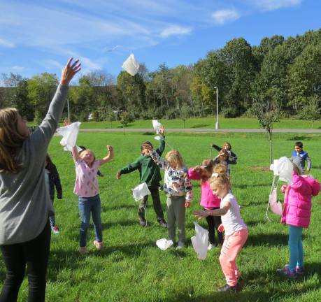 Mrs. Connell and her second-grade class launches their parachutes (Photo by Peg Snure)