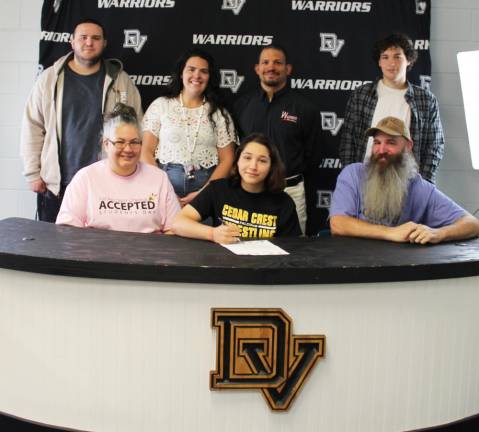 Senior Sarah Seltzer (front row center) with her mother and father, Penny and Scott Seltzer and (back row l-r) brother, Joseph Seltzer, assistant coach Karley May, head coach Evan Bates, and brother Michael Seltzer.