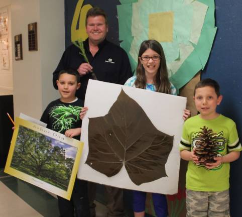 PCL&P ‘Leaves’ Arbor Day to the Experts Photo provided Pictured from left: PCL&P’s Mark Beamish, Michael John Noviski, Cassidy Baisley and Owen Ruzanski.