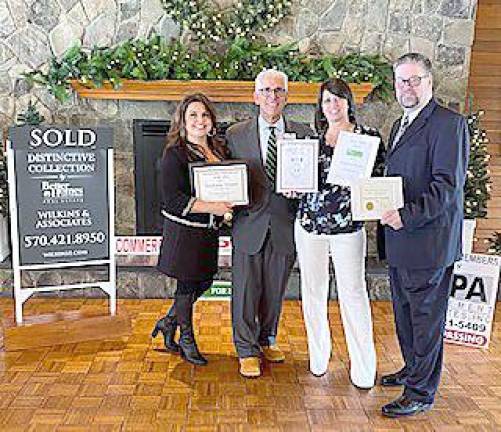 From left: Christine A. Wilkins, president/general manager; Thomas R. Wilkins, CEO; Stephanie Troiani, realtor; and William Schutte, executive vice president