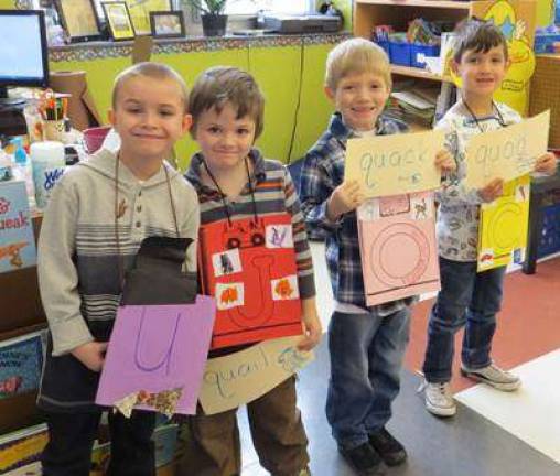 Kindergartners celebrate the union of 'Q' and 'U'! Groomsmen (from left): Conner Spangenburg, Jean-Luc Trumbull, Jourdain Stoll, and Chase Kurz (Photo by Peggy Snure)