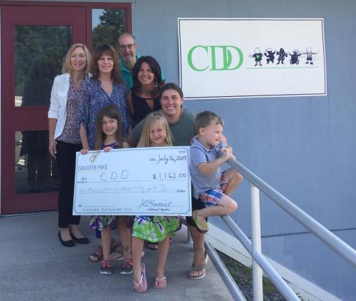 Pictured are Jenni Hamill, executive director of the Greater Pike Community Foundation; Christine Rolando, executive director of Center for Developmental Disabilities (CDD); Leo Macali, CDD parent; Vicki McCabe, family support specialist with CDD; Stefanie Malone, CDD parent; and Allison, Tiffanie and Bob Cross, scholarship recipients.