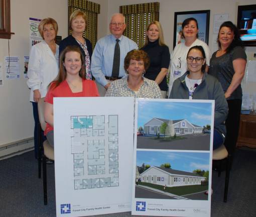 Wayne Memorial to build new health center in Forest City The staff of McAndrew Family Health Center with architectural renderings of the construction project soon to be underway in Forest City. Seated (from left): Stacey Cirba, MA; Pam Kresock, medical secretary and Tracy Johnson, LPN. Standing, JoAnne Sterchak, RN; Peggy Tomazic, RN; David Tomazic, DO; Krista Hollis, CRNP; Jo-Ann Sames, RN; and RickiLynn Derrick, medical secretary. (Photo provided)