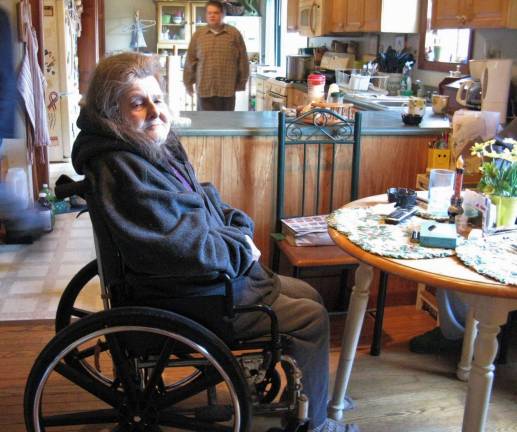 Doris France still home as new landlord helps out Doris France in her kitchen, with son David in the background in a photo taken last last year (Photo by Ginny Privitar)