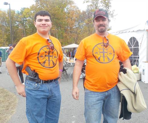 Nicholas Mele and his dad, Lou, are wearing shirts given to them by Kahr Arms.