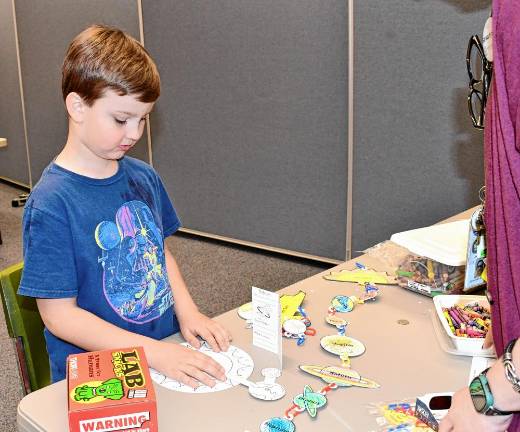 William Chazey of Vernon works on a project related to the eclipse Monday, April 8 at the Dorothy Henry library branch. (Photo by Maria Kovic)