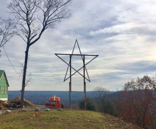 Don Quick and helpers installed the new star on his Milford Heights property (Photo by Don Quick)