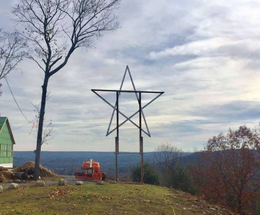 A new star is born in Milford Don Quick and helpers installed the new star on his Milford Heights property (Photo by Don Quick)
