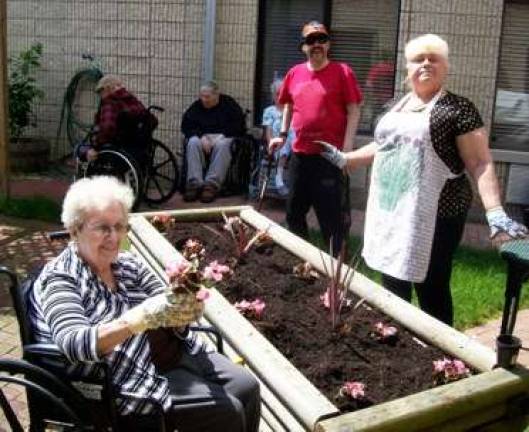 Home Depot volunteers lend green thumbs to Belle Reve Home Depot volunteers lend green thumbs to Belle Reve