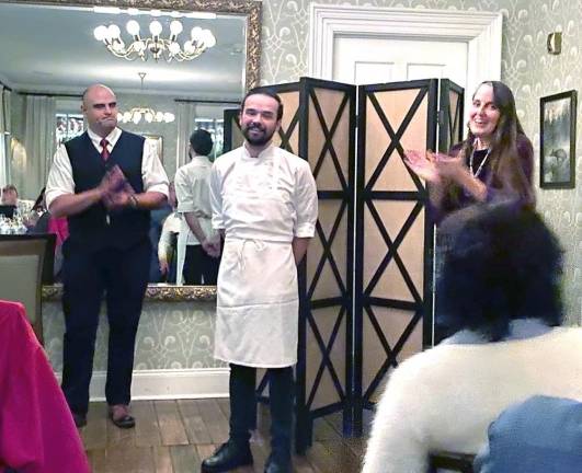 Bryce Stevenson, the chef de cuisine, flanked by Michael Zimmerman Jr. and Professor Margaret Noodin as the audience says thank you in Ojibwe for the delicious meal.