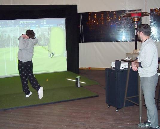 Mark Creamer, marketing and sales manager at Great Gorge Golf Club, watches a guest hit a tee shot in the long drive competition (Photo by Dr. John T. Whiting)