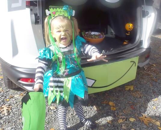Fairy princesses mingle with ghastly ghouls at Trunk or Treat This child's mother suggested she imitate a scary creature, and she didn't disappoint! (Photo by Frances Ruth Harris)