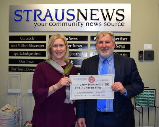Straus News Director of Sales and Marketing Frank Curcio presented the winning check to Cheryl Dicozstanzo, who won with her receipt from Etched in Time in Warwick.