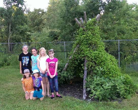 Red Razberries grow to love gardening The Rad Razberries 4-H Club gardens in a surprising way. This clever teepee has a covering formed by climbers that gradually grow up the structure. Now the children have a shady hideaway, with exceptional insulation and air quality -- but watch out for bugs! (Photo provided)