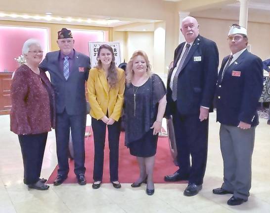 What makes America great? From left: Guyette Calles, District Auxiliary President; Wayne (Popeye) Perry, State Commander; Autumn Baker; Sandra Wilder, State Auxiliary President; William (Doc) Schmitz, National Commander; Rick Ellis, District Commander