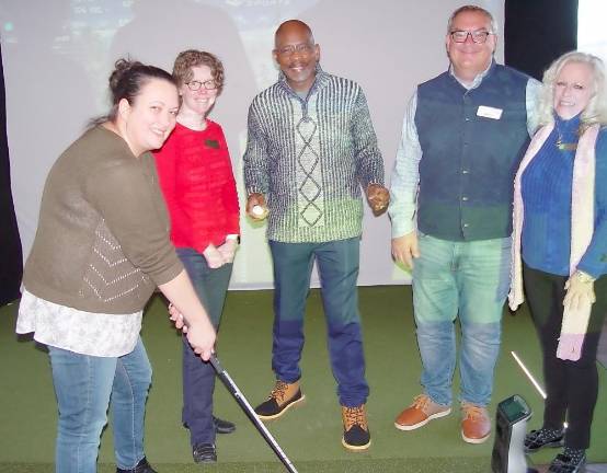 Vernon Mayor Howard Burrell (center) provides golf tips to Jennifer Lubliner, Vernon’s Economic Development Advisory Committee chair. They are pictured with Debbie Coulson, recording secretary for the Vernon Chamber of Commerce; David Killin, Great Gorge Golf Club general manager; and Elizabeth Cassidy, Warwick Chamber of Commerce President (Photo by Dr. John T. Whiting)