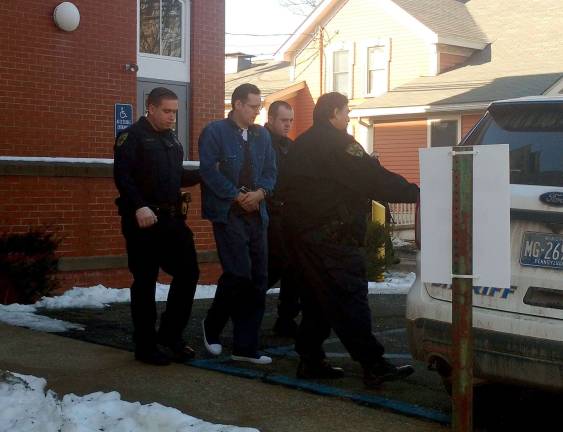 Police officers lead Eric Frein out from the Pike County Courthouse after the pre-trial motions hearing last December. (Photo by Anya Tikka)