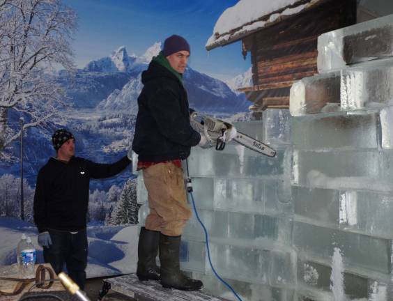 Immerse yourself in 'Frozen' world From left: ice sculptors John Morton and Joshua Clemens prepare one of their frozen creations (Photo by Chris Wyman)