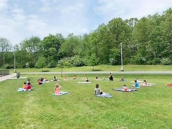 A kindergarten class learns yoga