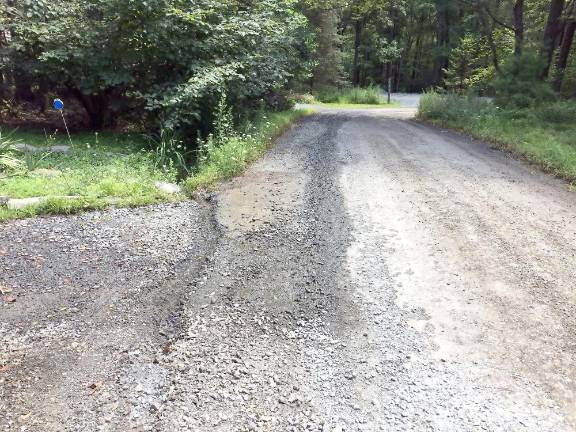 This photo shows the road damage in front of Virginia Pfeiffer’s house in Sagamore Estates last year, caused by a leak that was allowed to run for over a month (Photo provided)