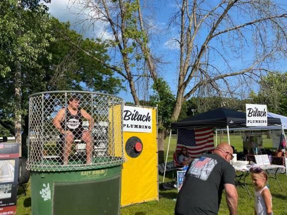 The dunk tank was sponsored by Daniel Bilach Plumbing .