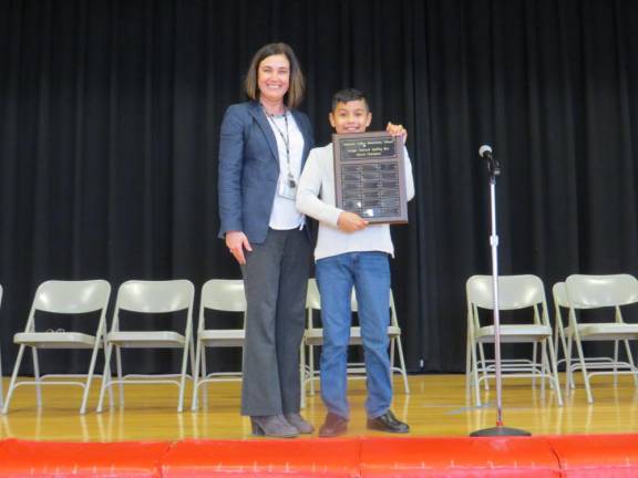 DVES Principal Mary Ann Olsommer congratulates Eddie Arias on his first-place finish in the Spelling Bee.