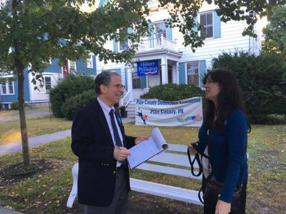 Are you registered to vote? There's still time! Franklin Moss talks to potential voter Beth Billiard outside Democratic headquarters at 511 Broad St., Milford (Photo provided)