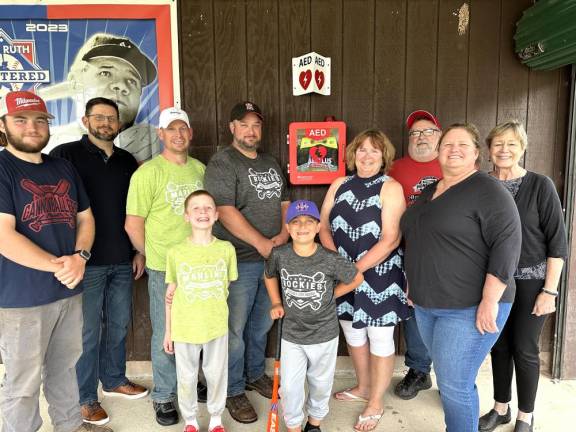 Honesdale. Rotary buys an AED for baseball association Camden Bunting, Tanner Cottell (front row) with (back row) Matt Abbott, Chris Tallman, Paul Bunting, Adam Cottell, Rotary Past President Sherry Grandinetti, current President Dana Scott, Charlie Rollison, and Rotarian Lisa Champeau.
