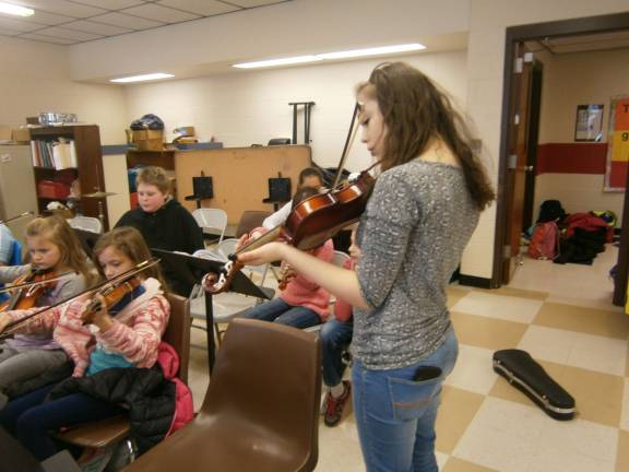 Orchestra students learn by mentoring Pictured in the front row (from left): Elizabeth G., Brooke M., and Ashley Kizis (Photo provided)