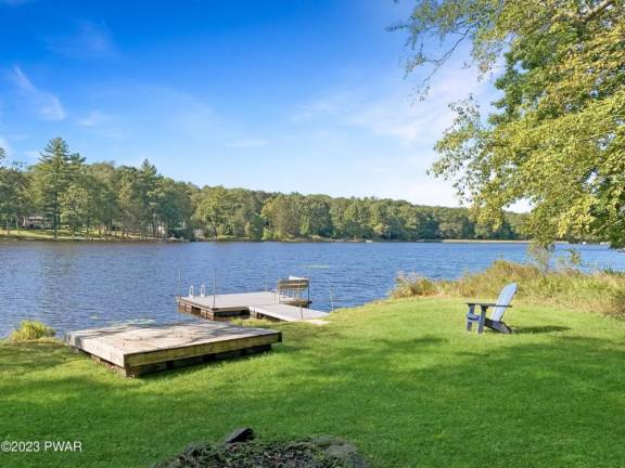 This private lakefront home features a dock, raft, and boathouse
