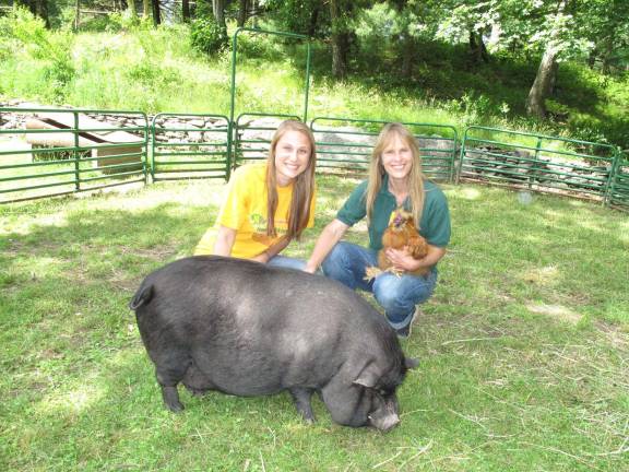 All creatures great and small Rebecca and her mom Donna with a pot bellied pig and a chicken