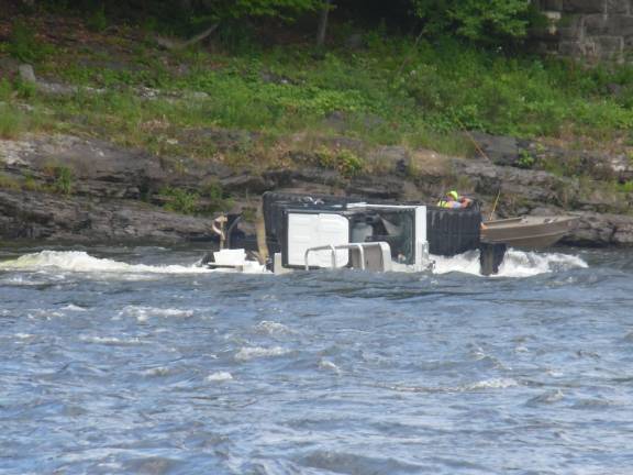 Bridge inspectors saved from river currents The overturned tracker (Photo by Anya Tikka)