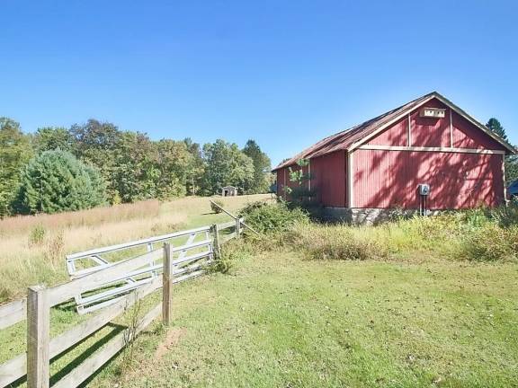 Mountaintop equestrian estate includes modern home and pond Barn