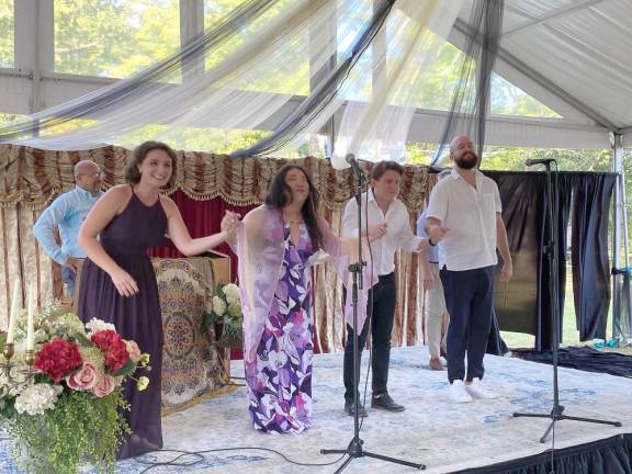 José Meléndez, AVA conductor/ vocal coach standing behind the piano, as Emily Margevich, Alice Chung, Zachary Rioux, and Benjamin Dickerson all take a bow.