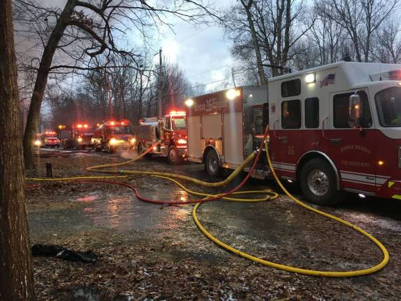 Dingman firefighters answer record 16 calls over MLK weekend Firefighters work to locate the fire under the fire place on Long Ridge Road in Hemlock Farms. (Photo provided)