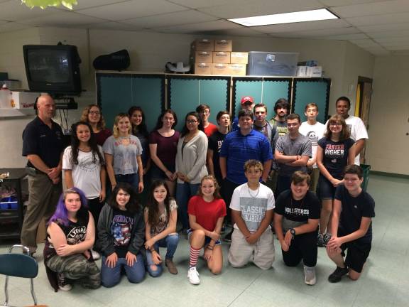 Put fire safety first Bill Koferl, president of the Westfall Volunteer Fire Department, and Mrs. Peters' Family and Consumer Science (FACS) class during a recent fire safety lesson (Photo provided)