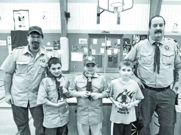 Race Time at the Pinewood Derby From left Team Weblos members Matthew Guadagni (10) of Milford, Paul Guadagni (10) of Milford and Tyler Fean (9) of Milford holding the trophys they won.