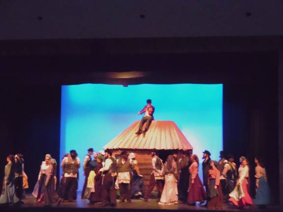 Delaware Valley High Drama Club raises the roof with 'Fiddler' Opening scene, with the fiddler playing on the roof. (Photos by Anya Tikka)