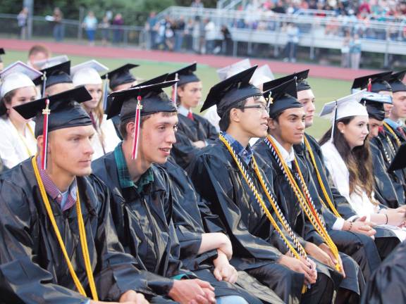 Graduates listen during the ceremony