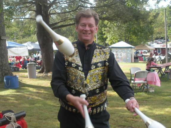 Fall fun at Harvest Festival Photo by Mary Caraballo Mark Clark a magician, juggler and balloon sculptor.