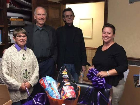 'Martinis and Manicures' get-togethers help local causes Dave Chant of Chant Realtors picks up his purple ribbons from board president Valerie O’Hare and board member Cheryl O’Sullivan. (Photo provided)